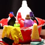 Household cleaning products in a red basin