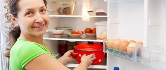 Woman putting a saucepan in the refrigerator